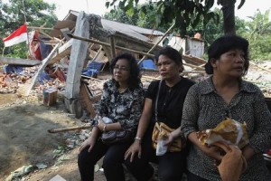 Members of congregation of Batak Christian Protestant Church sit near ruins of church after excavator demolished it in Taman Sari of Bekasi